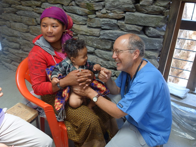 Dr. Sagin delivering medical care on a service trip in Nepal.